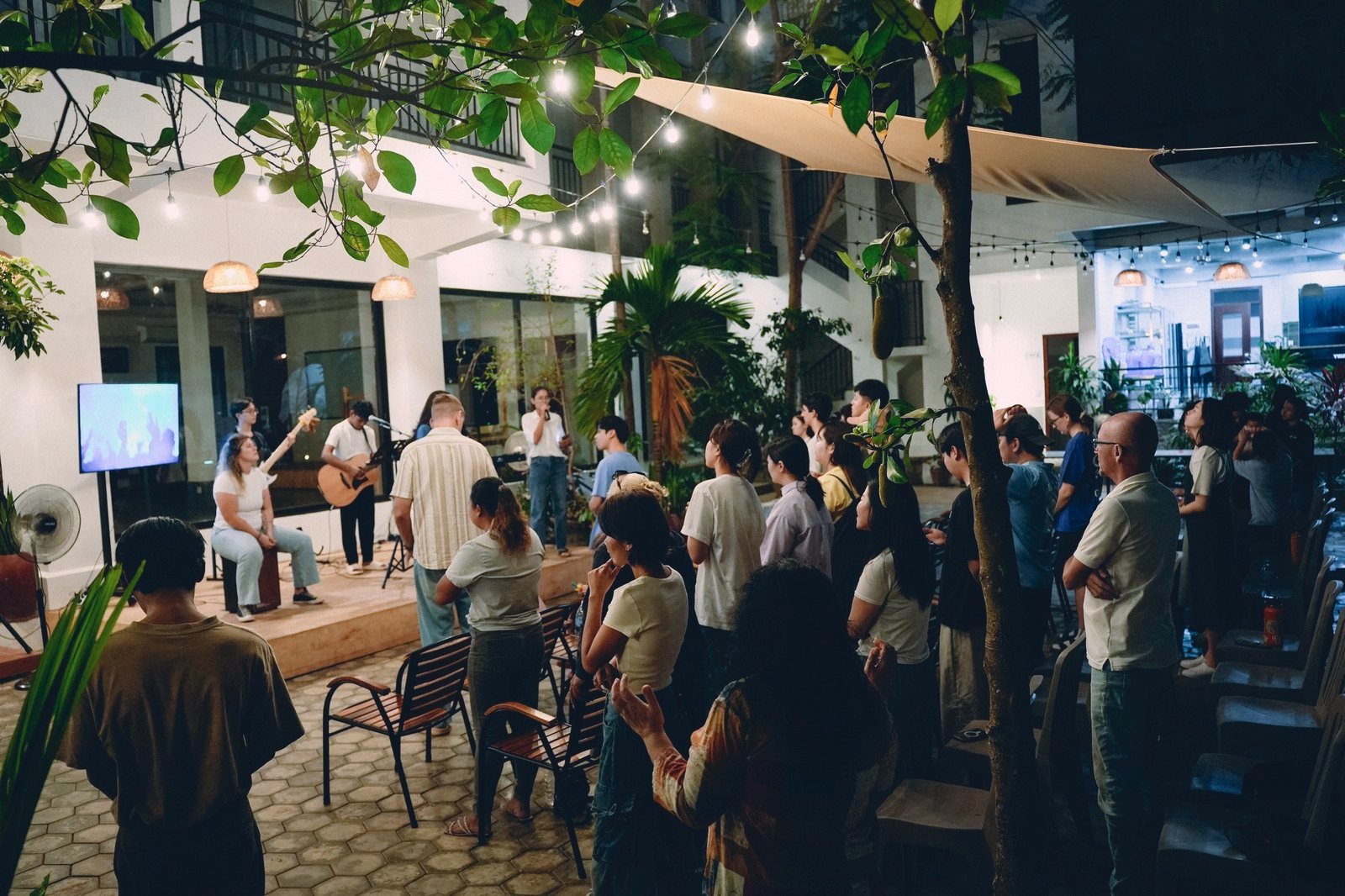 Community night: the base worshipping together under string lights