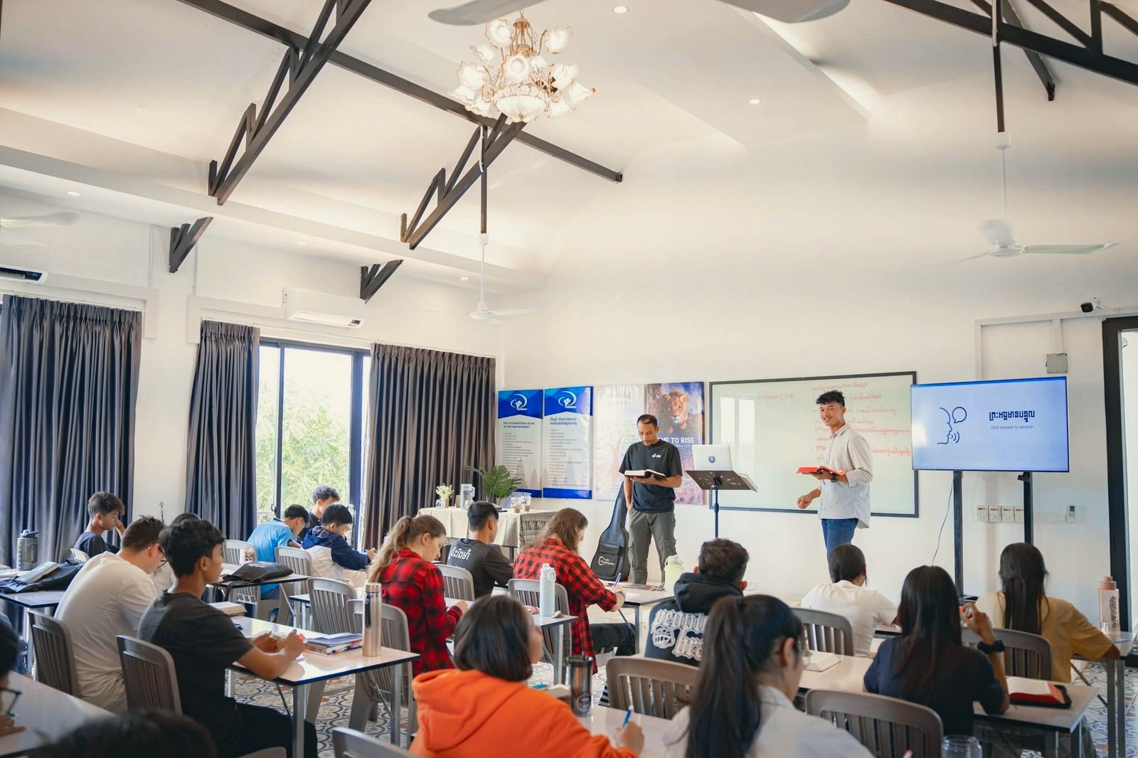 A DTS lecture on hearing God's voice — students in class with a speaker and translator at the front