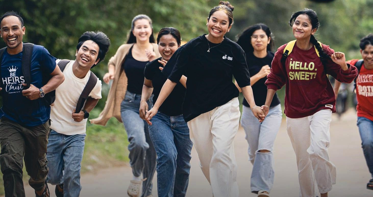 DTS students running down a road together, laughing