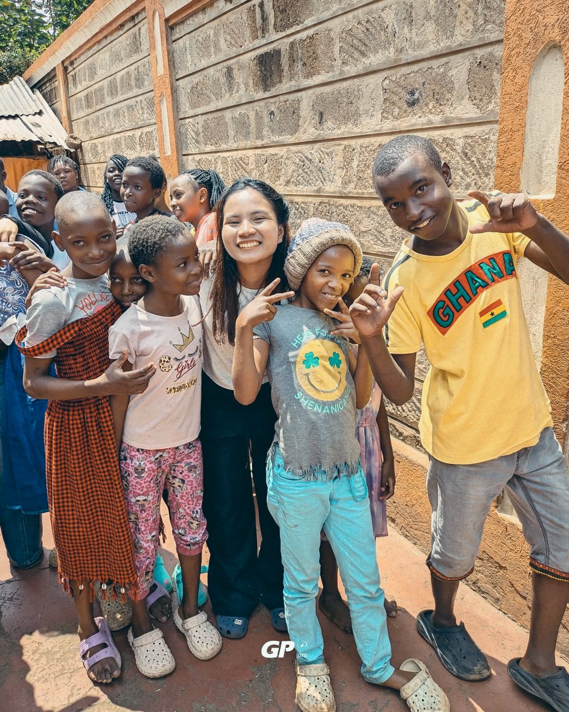A DTS student laughing with a group of children on outreach