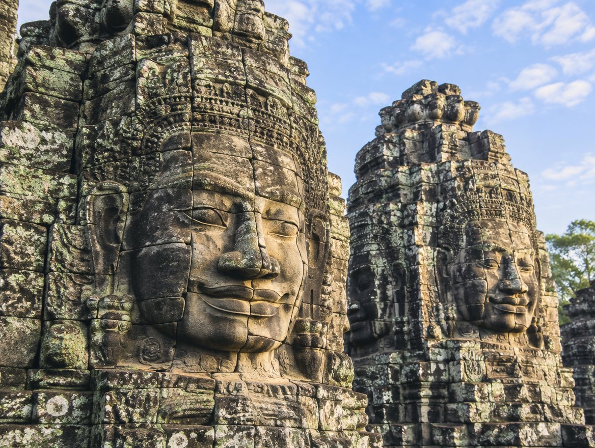 Giant smiling stone faces carved into the towers of the Bayon